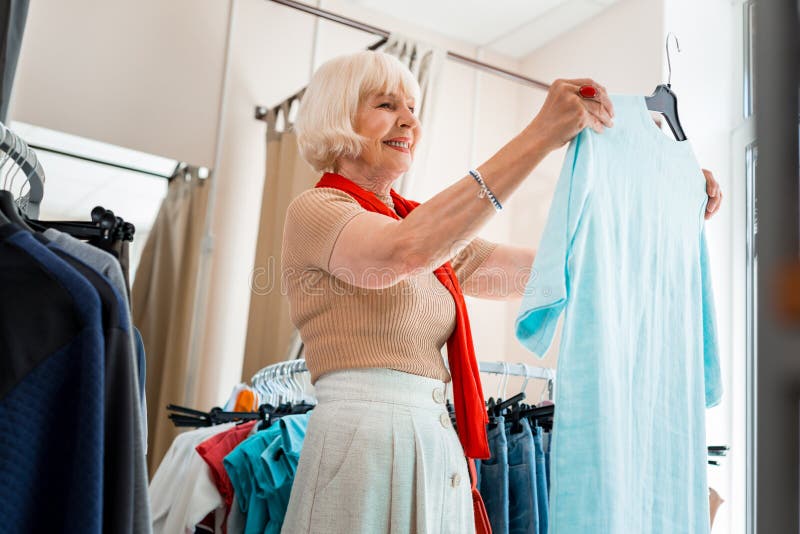 Pleased Elderly Woman Admiring Summer Dress in Clothing Store Stock ...