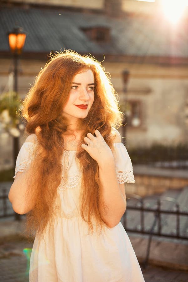 Tender Ginger Girl With Long Hair Wearing White Dress With Naked Stock