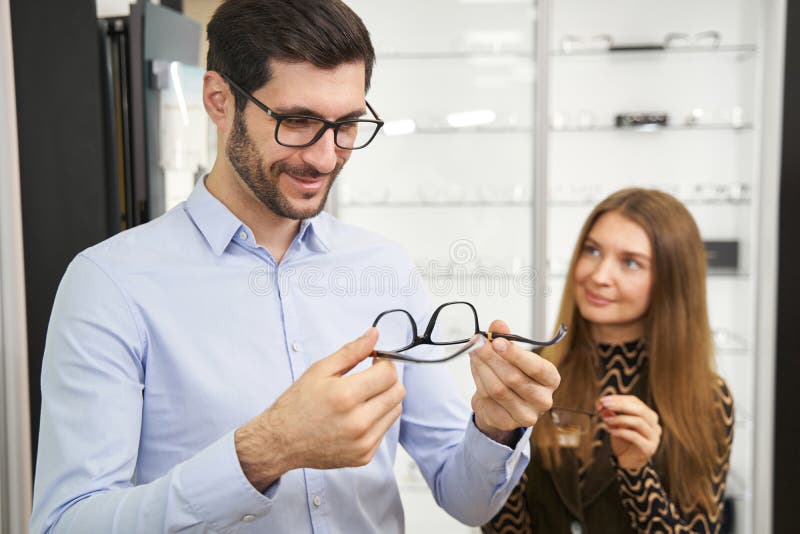 Sales Assistant Suggesting Another Pair of Glasses To Customer Stock ...