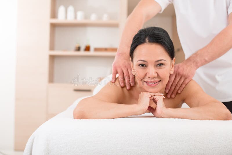 Glad female getting a massage at spa stock image Glad female getting a massage at spa stock image