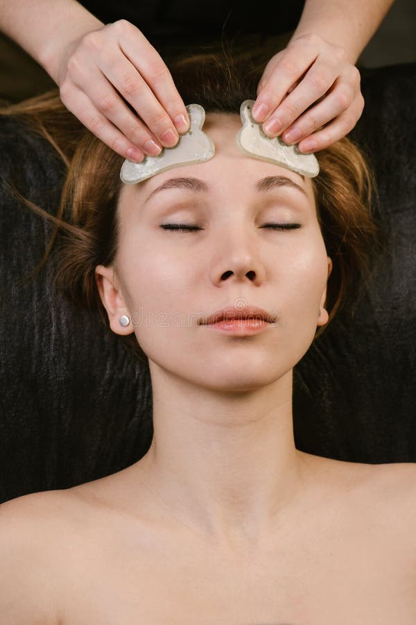 Pleased Woman Receiving Forehead Massage In A Beauty Salon Stock Image