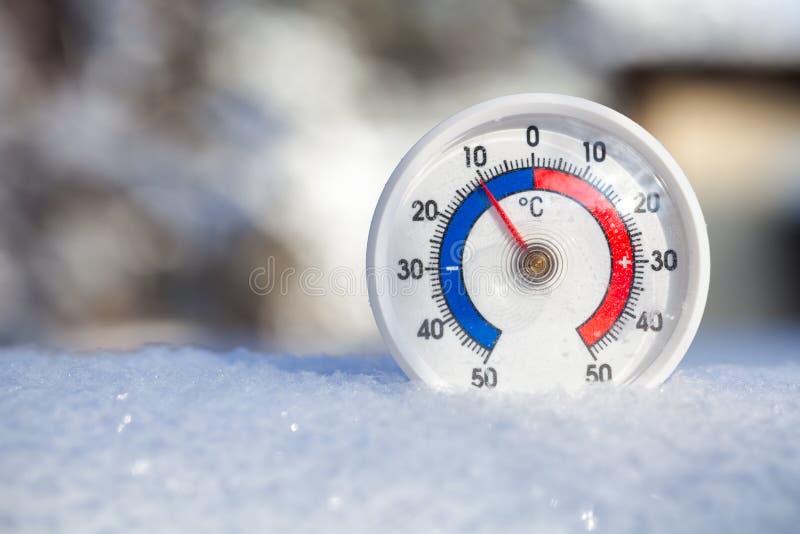 Plenerowy termometr w śniegu pokazuje poniżej zera temperaturowego zimnego wint