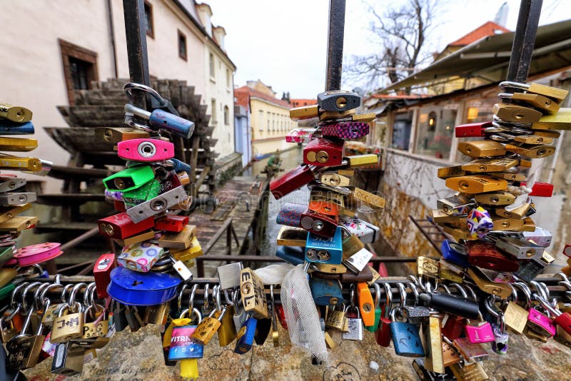 Plenty of padlocks on the railing of bridge by the historic mill royalty free stock images