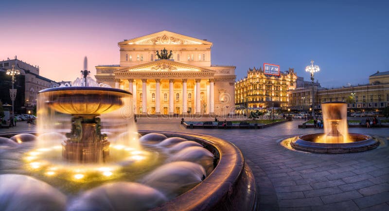 The jets of a fountain near the Bolshoi Theater with evening lights. The jets of a fountain near the Bolshoi Theater with evening lights