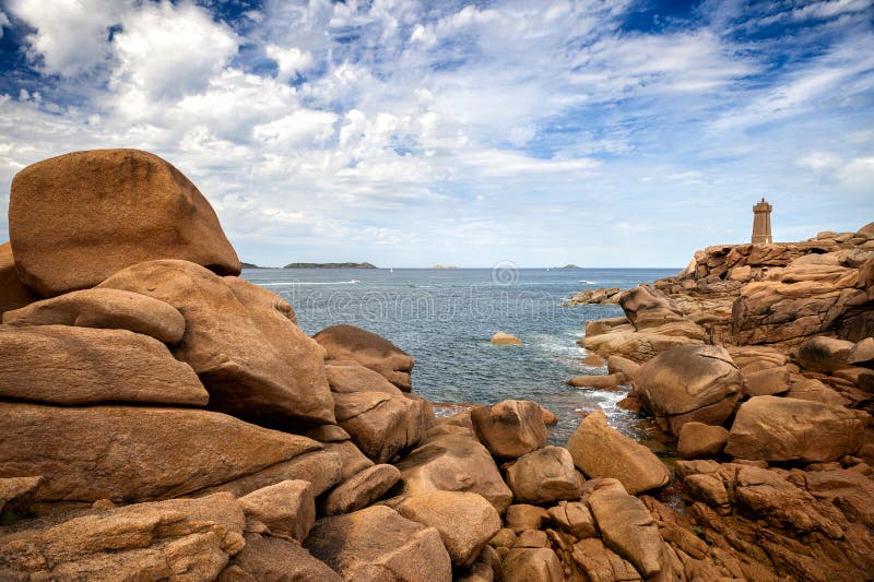 Ploumanac`h Mean Ruz lighthouse between the rocks in pink granite coast, Perros Guirec, Brittany, France.