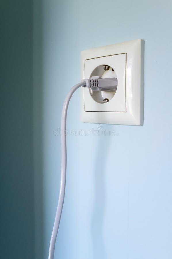 Plug with Cable Cord Connected To the Socket, on a Blue Wall. Stock Image Image of background