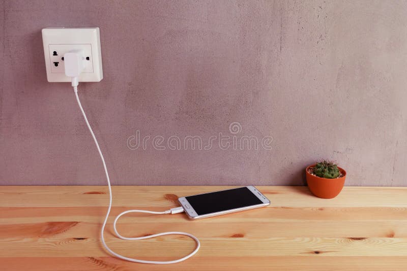 Plug in Power Outlet Adapter Cord Charger of Mobile Phone on Wooden Stock  Photo - Image of device, cable: 139636996