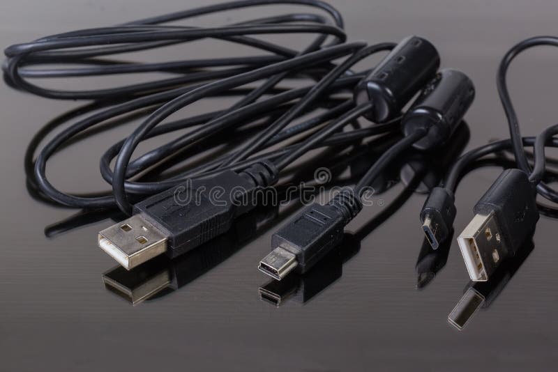 Plugs USB, MicroUSB and MiniUSB on Cables Edges Stock Photo Image