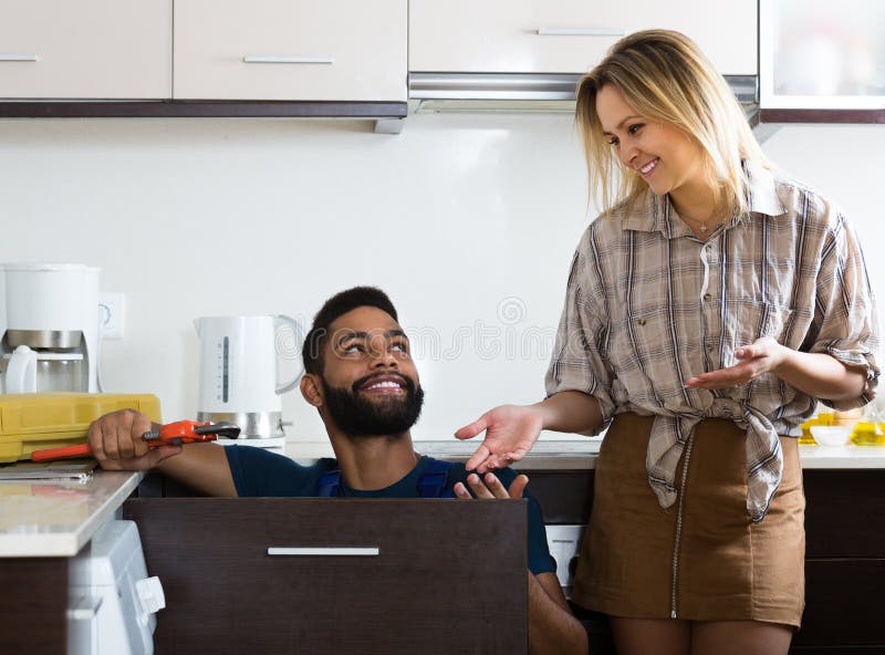 Plumber and Housewife in Kitchen Stoc