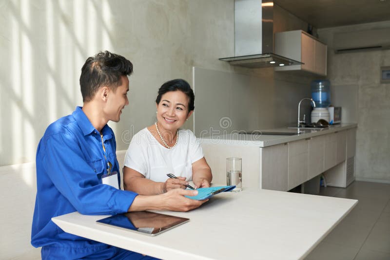 Plumber and Housewife in Kitchen Stoc