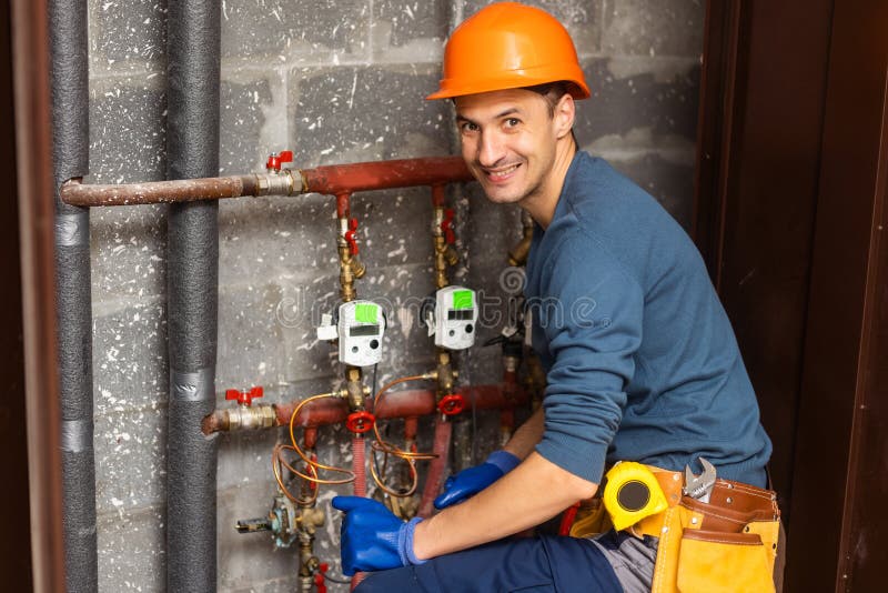 Plumber Installing Pressure Meter for House Heating System Stock Photo