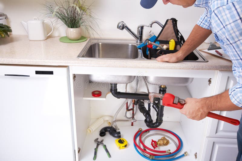 Plumber on the kitchen. stock image. Image of commercial 64480179