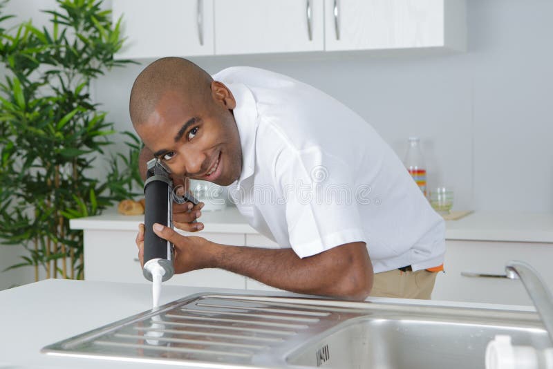 Plumber Putting Silicone Sealant To Installing Kitchen Sink Stock Image Image of silicone
