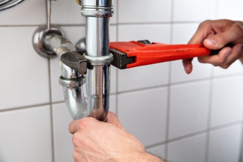 Plumber Repairing Sink With Adjustable Wrench royalty free stock photography Plumber Repairing Sink With Adjustable Wrench royalty free stock photography