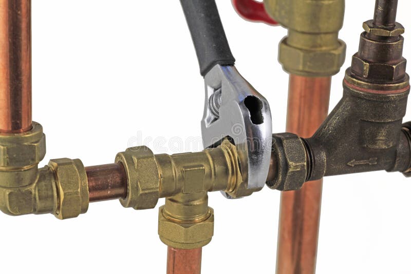 Plumber`s adjustable wrench tightening up copper pipework