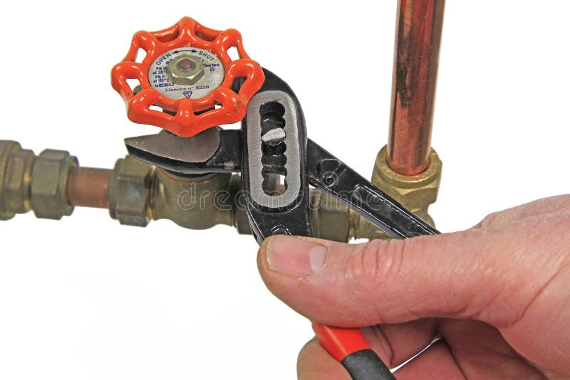 Plumber`s wrench tightening up a valve