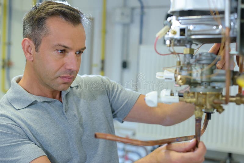 Plumber at Work on Workbench To Fix Pipes Stock Image Image of