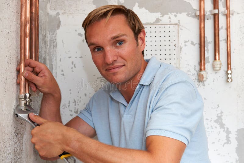Plumber Working on Pipes at Construction Site Stock Photo Image of