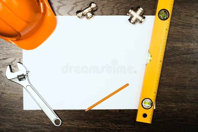 Plumbing tools on a white sheet of paper. Helmet, details.