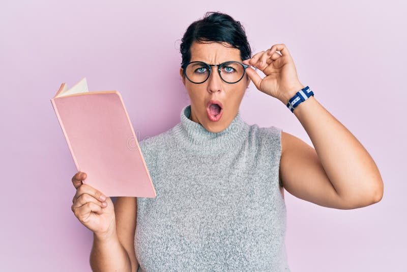 Plus Size Brunette Woman Reading a Book Wearing Glasses in Shock Face 