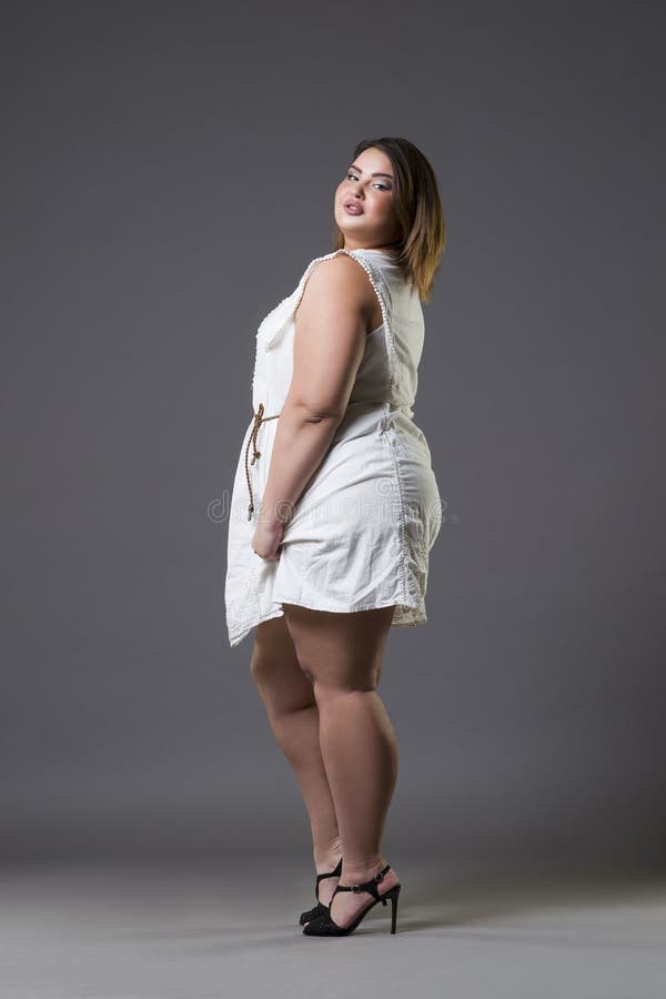 Plus size fashion model in casual clothes, fat woman on gray background, overweight female body royalty free stock image Plus size fashion model in casual clothes, fat woman on gray background, overweight female body royalty free stock image