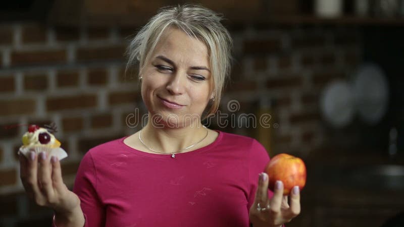 Plus size woman choosing between apple and cake