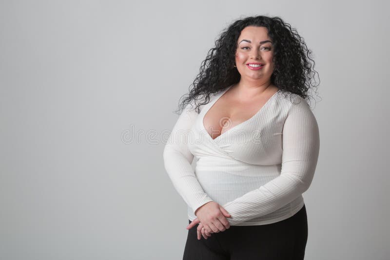 https://thumbs.dreamstime.com/b/plus-size-woman-deep-cleavage-big-breast-posing-studio-happy-toothy-smile-overweight-female-model-curly-dark-hair-230060550.jpg