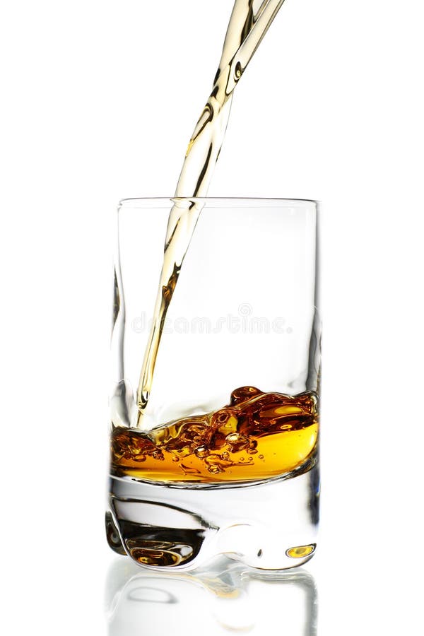 Elegant drinking glass with poured amber liquid. Elegant drinking glass with poured amber liquid