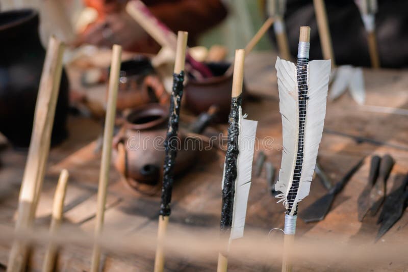 Homemade wooden archery arrows with fletching at medieval historical outdoor festival - close up, selective focus. Handmade, hunting and sport concept. Homemade wooden archery arrows with fletching at medieval historical outdoor festival - close up, selective focus. Handmade, hunting and sport concept