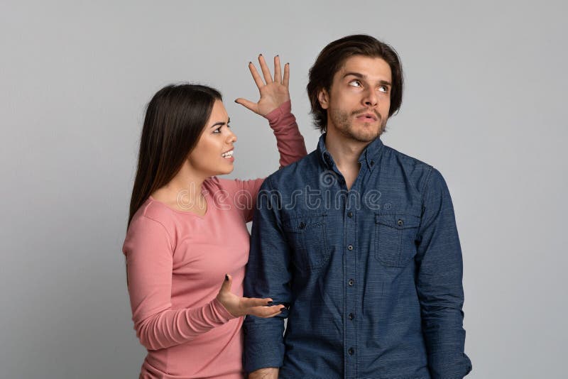 PMS Syndrome. Angry Young Woman Emotionally Screaming At Annoyed Husband royalty free stock photo PMS Syndrome. Angry Young Woman Emotionally Screaming At Annoyed Husband royalty free stock photo