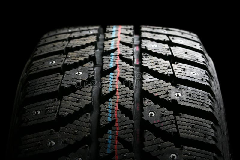Brand new winter tire pattern on black background. Brand new winter tire pattern on black background