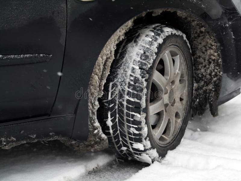 Closeup of a dirty car tire in winter with snow slush. Closeup of a dirty car tire in winter with snow slush.