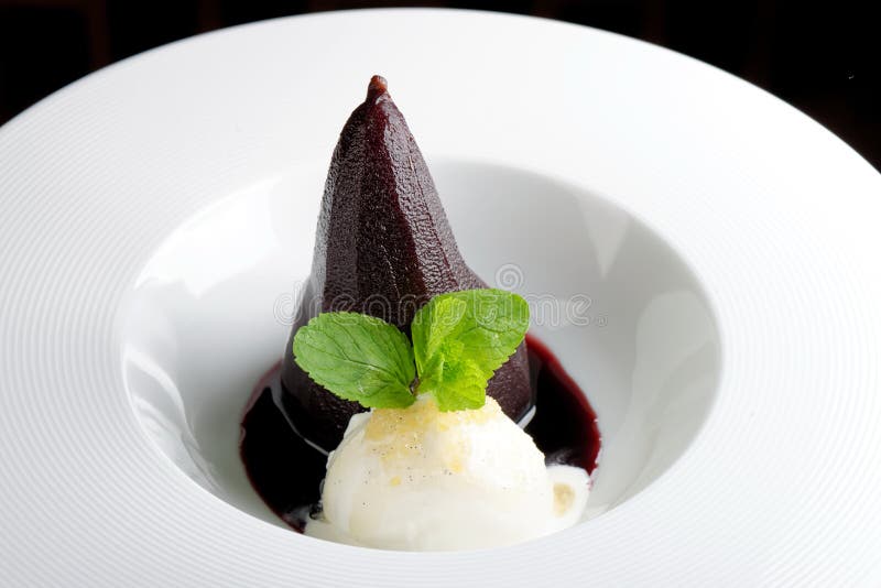 Poached pear and ice cream with red wine sauce