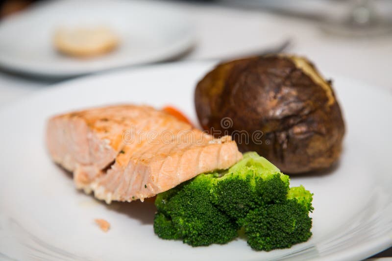 Poached Salmon with Broccoli and Baked Potato stock images
