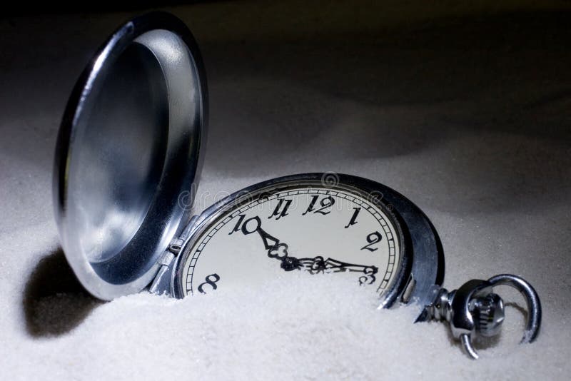 Pocket watch covered with sand