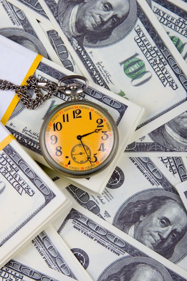 Pocket watch on a stack of dollars