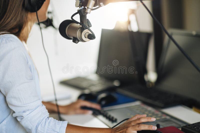 Podcast Concept - Female Host in Podcasting Studio royalty free stock photography