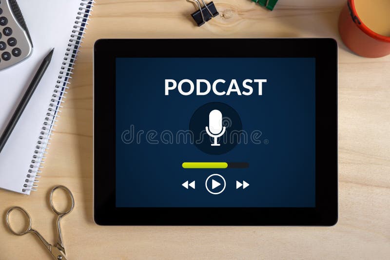 Podcast concept on tablet screen with office objects on wooden d stock photo