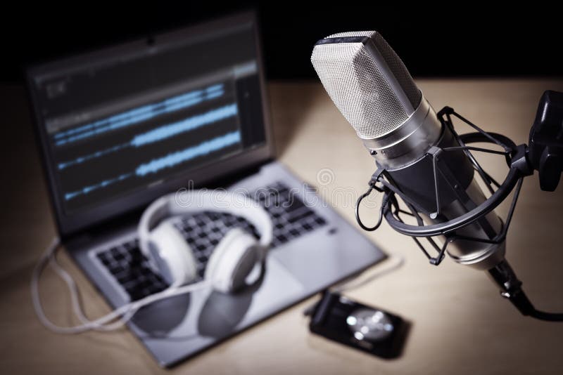 Podcast microphone and laptop computer in recording studio