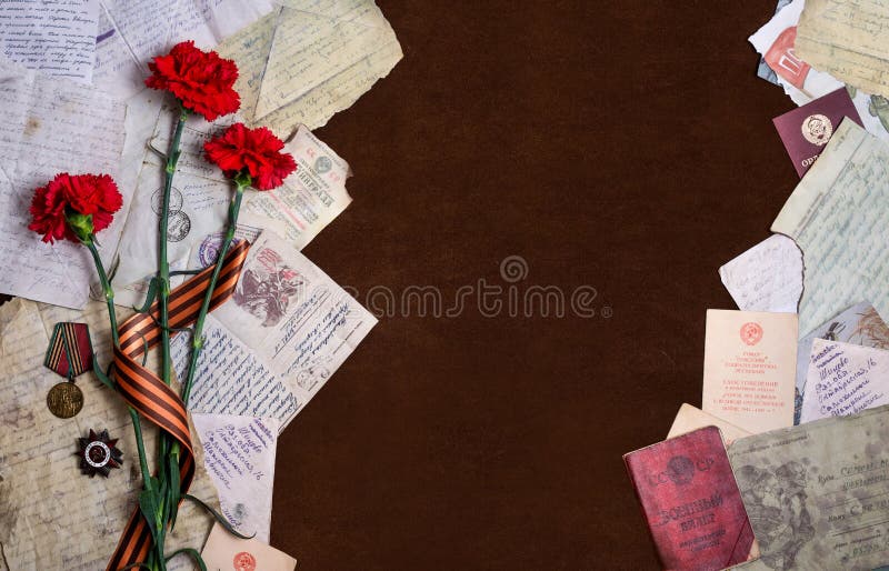 Beautiful background dedicated to Victory Day. Three red carnations, order and medal, letters from the Front and place for greeting inscription. Beautiful background dedicated to Victory Day. Three red carnations, order and medal, letters from the Front and place for greeting inscription.