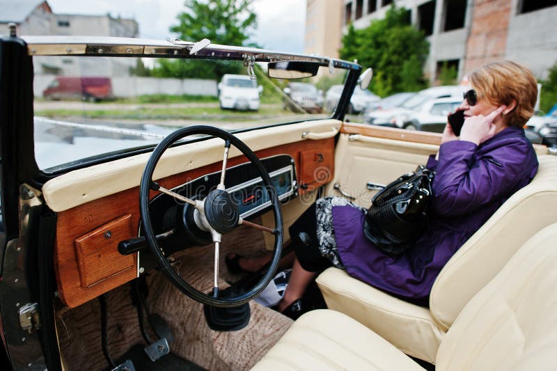 Podol, Ukraine - May 19, 2016: Dashboard and steering wheel of Maybach Zeppelin DS 8 Roadster, luxury classic car. Podol, Ukraine - May 19, 2016: Dashboard and steering wheel of Maybach Zeppelin DS 8 Roadster, luxury classic car.