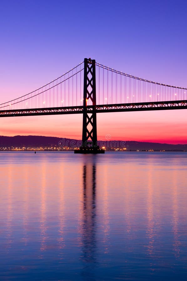 The Bay Bridge in San Francisco silhouetted against a clear sky just before sunrise. The Bay Bridge in San Francisco silhouetted against a clear sky just before sunrise.
