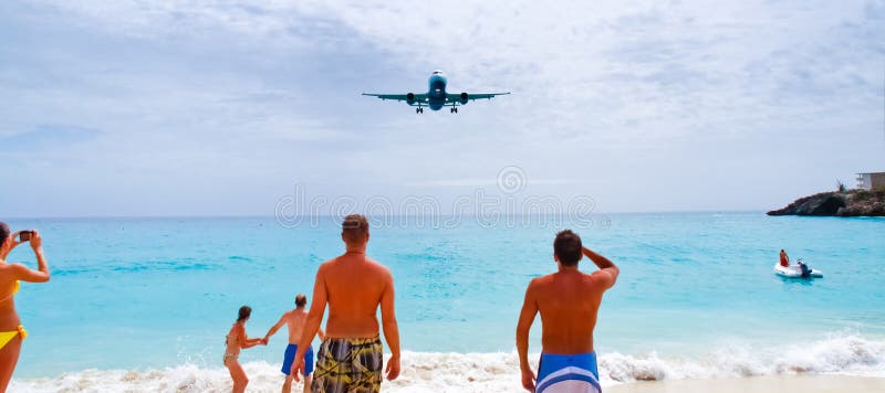 A US Airways flight flys over onlookers at Maho Bay beach as it arrives at Princess Juliana International Airport in St. Maarten in the Netherlands Antilles, or Dutch West Indies. A US Airways flight flys over onlookers at Maho Bay beach as it arrives at Princess Juliana International Airport in St. Maarten in the Netherlands Antilles, or Dutch West Indies.