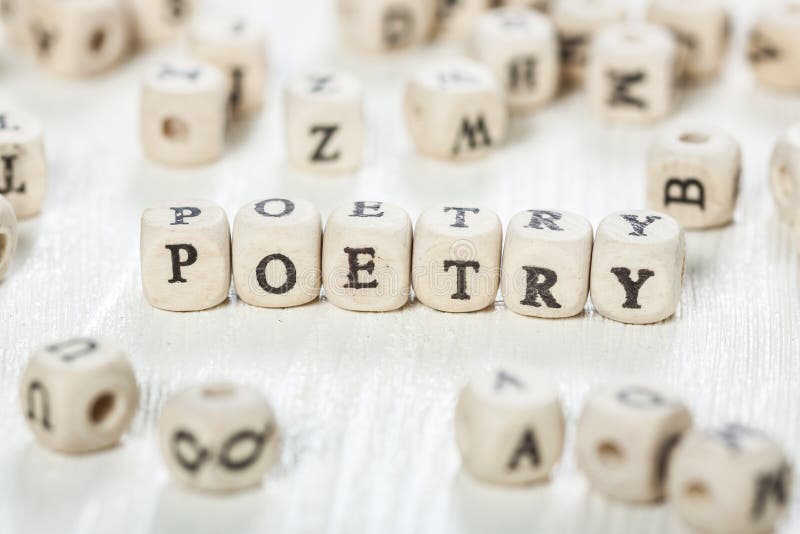 Poetry word written on wood block. Word POETRY formed by wood alphabet blocks. On old wooden table stock image