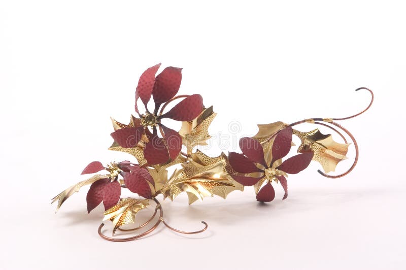 Wall decorations made of a metal foil imitating poinsettias with gold leaves. Christmas wall hanging. Wall decorations made of a metal foil imitating poinsettias with gold leaves. Christmas wall hanging