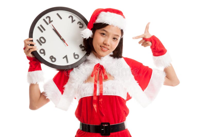 Point asiatique de fille de Santa Claus de Noël à l'horloge à minuit