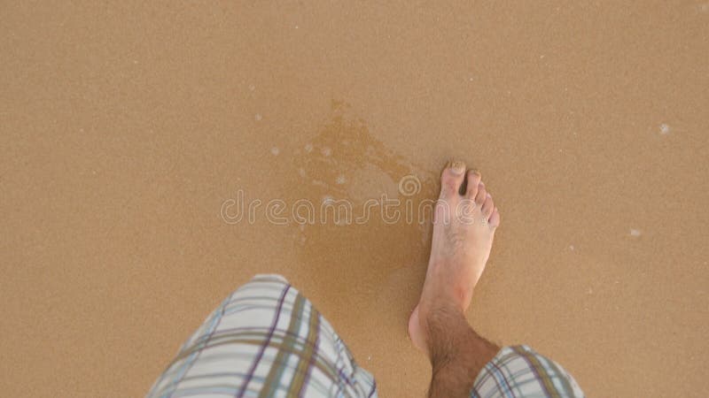 Point of view of young man stepping at the golden sand at sea beach. Male legs walking near ocean. Bare foot of guy royalty free stock photo Point of view of young man stepping at the golden sand at sea beach. Male legs walking near ocean. Bare foot of guy royalty free stock photo