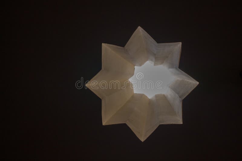 8 pointed star hole through a wall on display royalty free stock photography