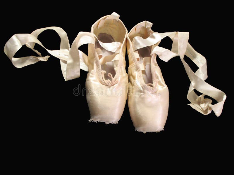 One pair of pointe shoes isolated on black. One pair of pointe shoes isolated on black