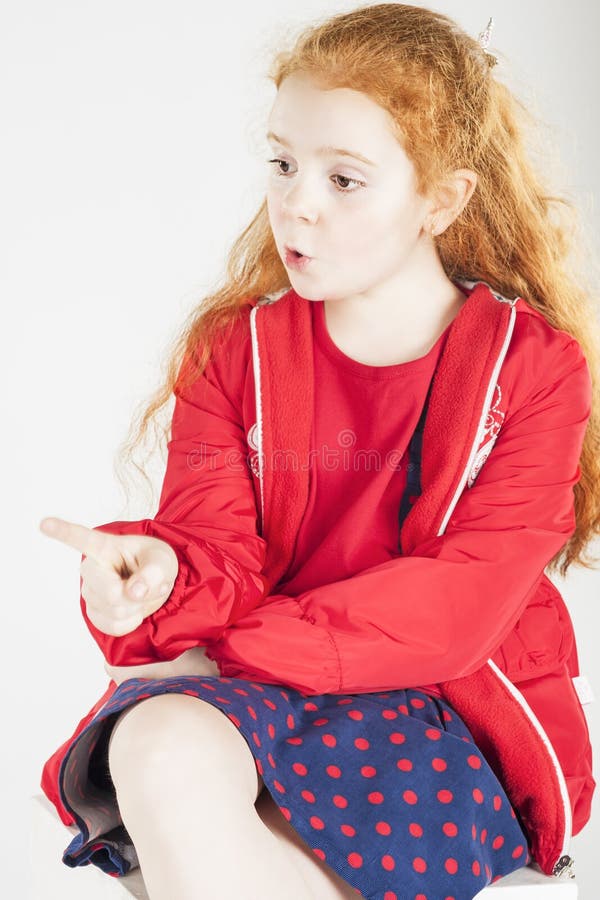 Pointing Little Red-haired Caucasain Girl with Surprised Express